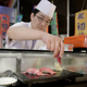 A sushi chef serves pieces of the 200-kilogram bluefin tuna sold for $117,000. (EPA/Kiyoshi Ota)
